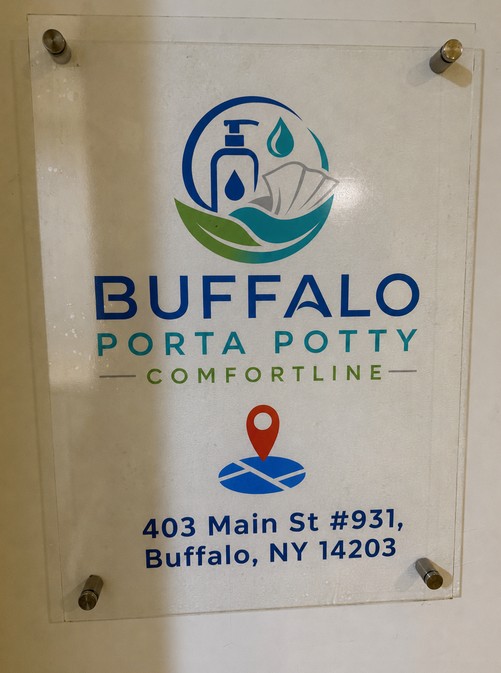 Buffalo Porta Potty Comfortline acrylic store sign showing the logo and the full address — 403 Main St #931, Buffalo, NY 14203